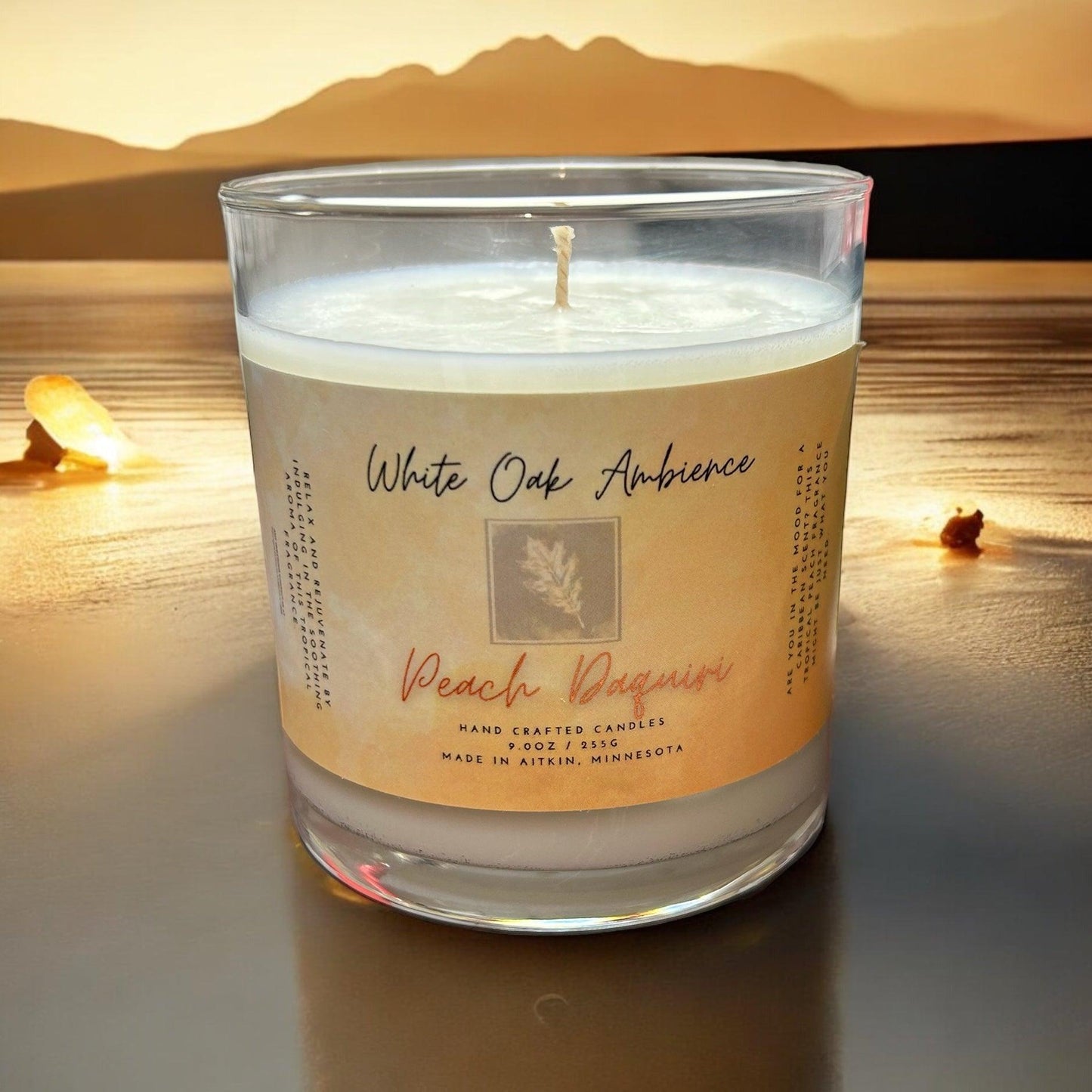 White Oak Ambience Peach Daiquiri coy candle in a clear glass jar with white wax and label, luxury scented wax for home fragrance.