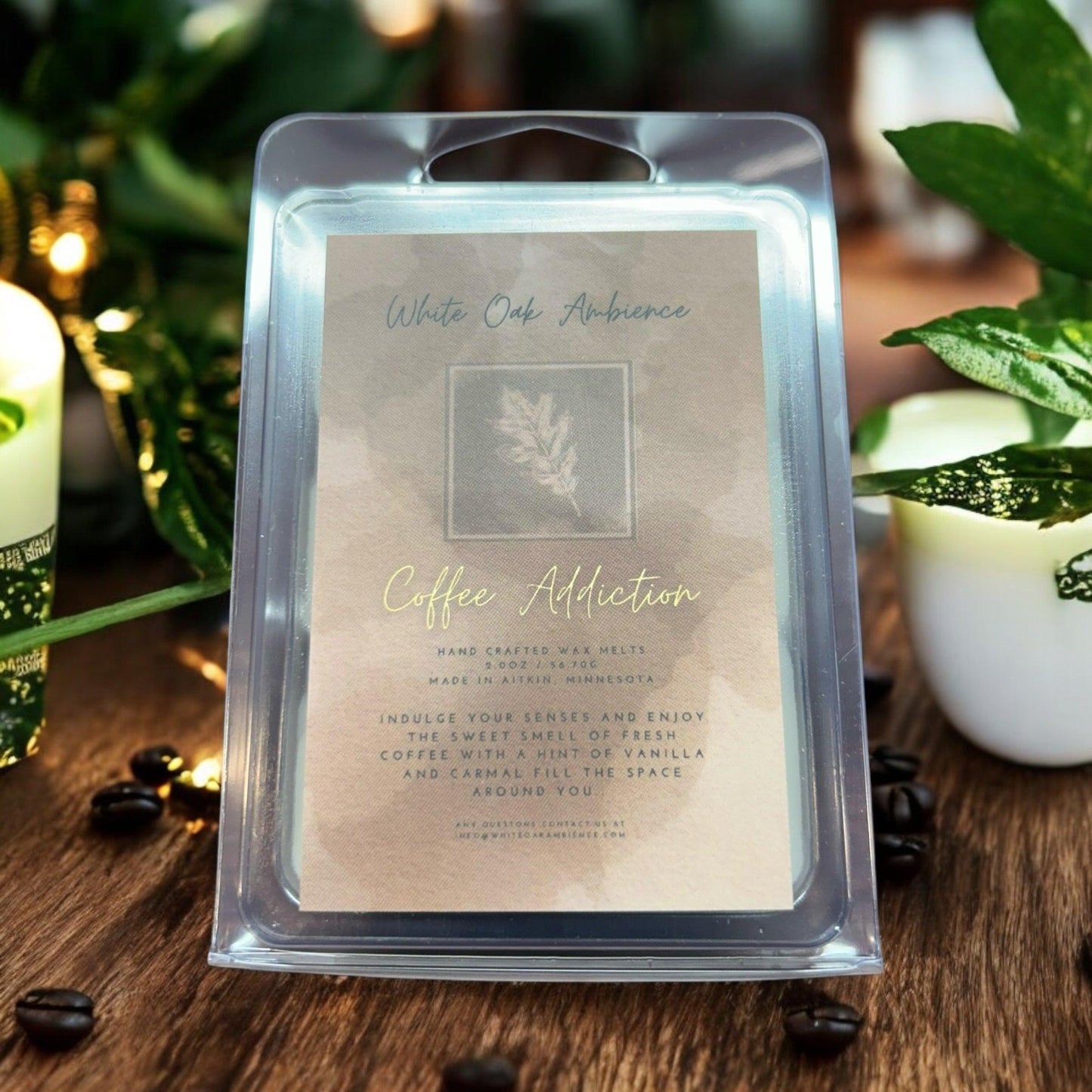 Wax melt packaging labeled 'Coffee Addiction' with a plant and coffee beans in the background