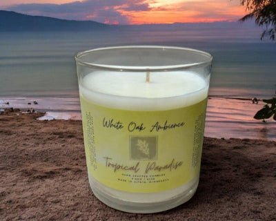 White Oak Ambience Tropical Paradise coy candle in a clear glass jar with white soy wax and label – luxury scented wax for tropical fragrance.