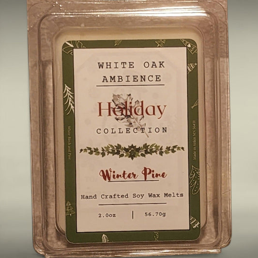 Packaged wax melt in clear container with green and white holiday themed label reading 'Winter Pine' and 'Holiday Collection'.